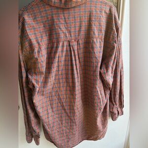 A orange and blue plaid button up man shirt